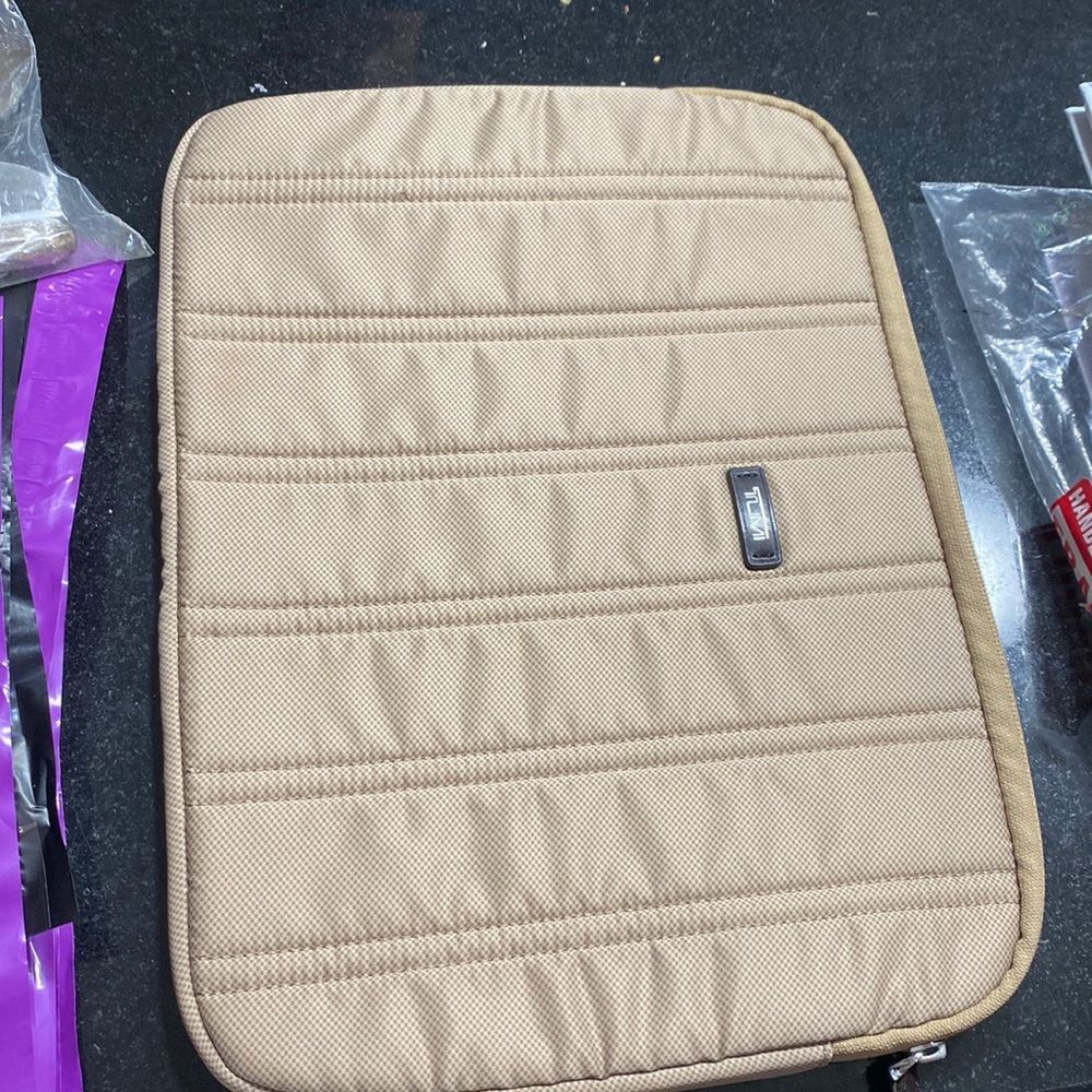 14” wide Tumi  laptop sleeve 10 1/2 inches tall zipper beige color